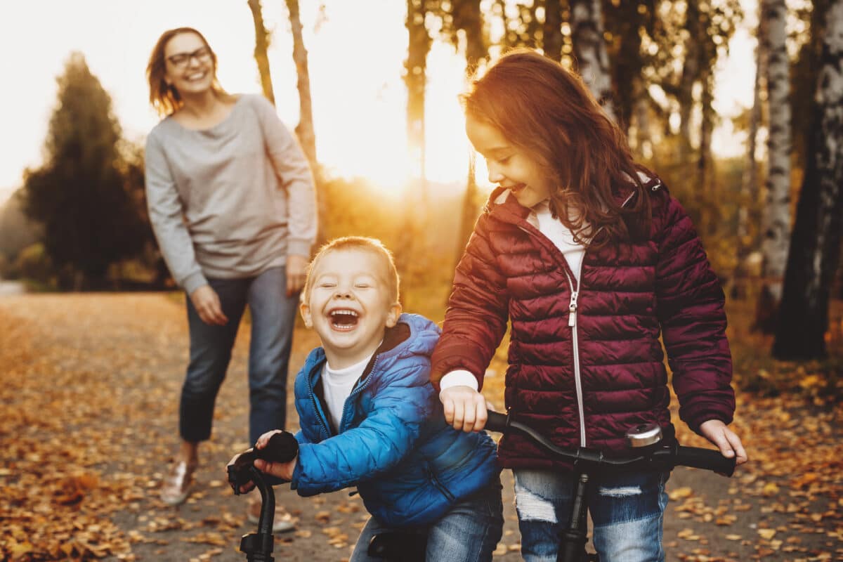 Portrait of a brother and sister playing with their bicycles out Family NDIS support application